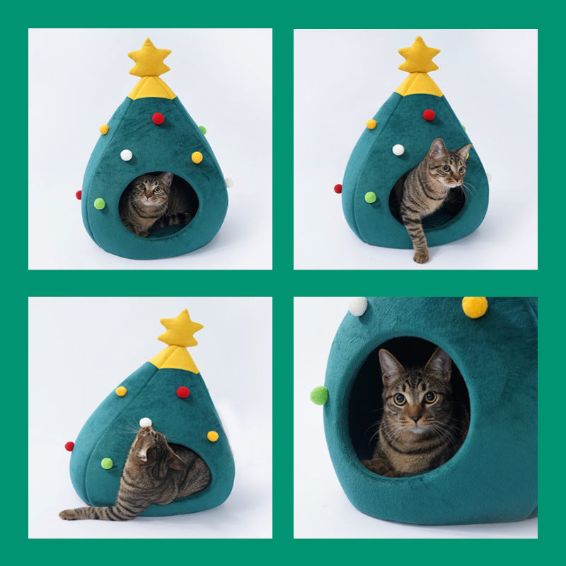 Cat sitting inside a green Christmas tree shaped cat bed